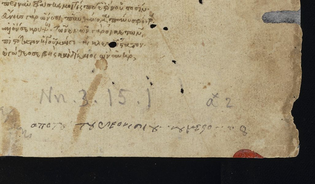 page from MS Nn.3.15 showing greek text and fragment of red seal