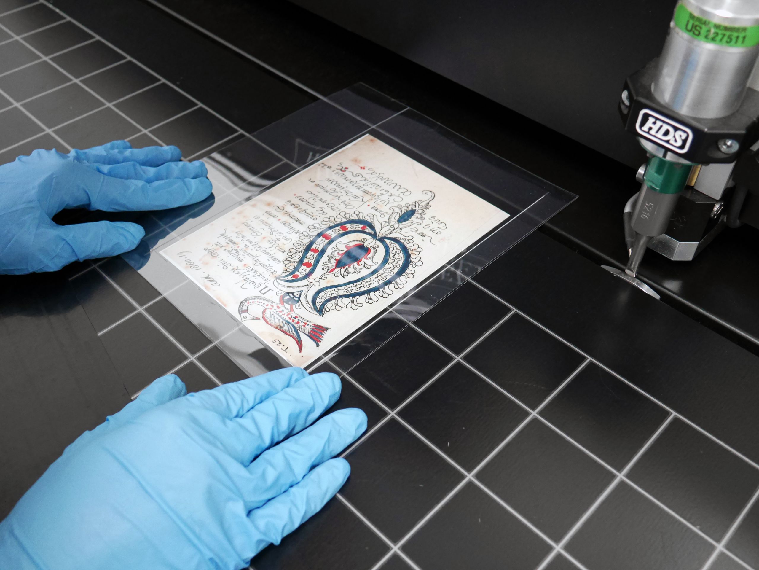 manuscript leaf being sealed with a melinex envelope