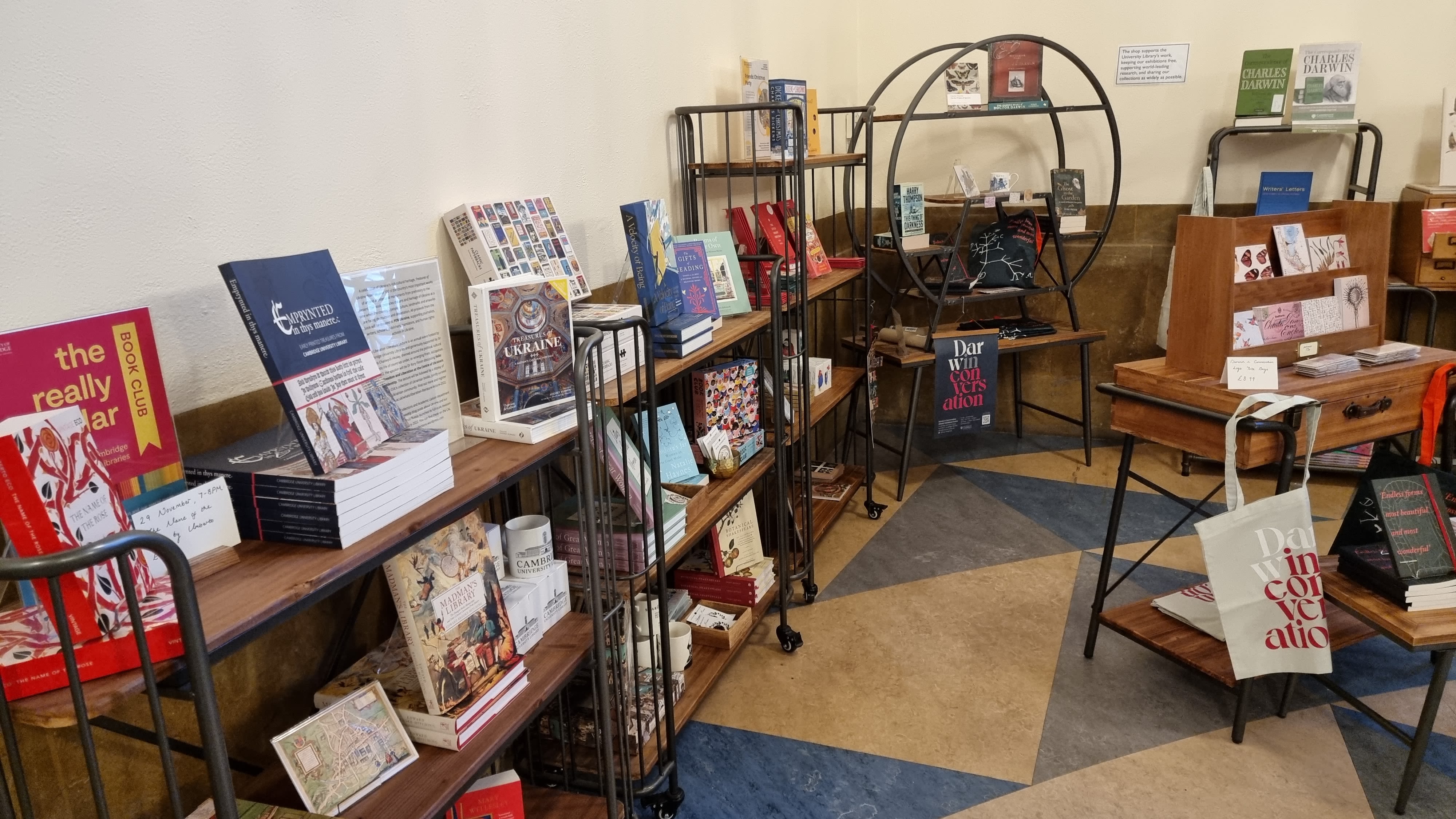 Books are displayed on open shelves in the shop