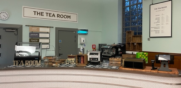 The Tea Room counter is set up with cake display cabinets, drinks machines and a pay point