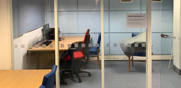 View of Study Room 2 through the glass front showing a desk, PC and chair